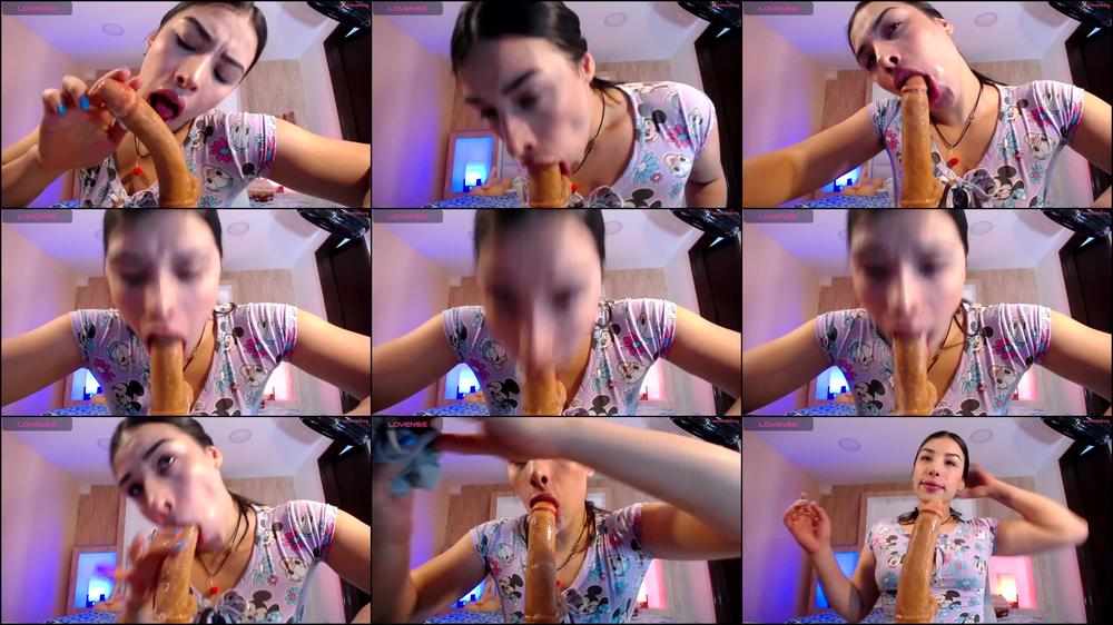 Teen temptress sucks on huge dildo, chin coated in spit